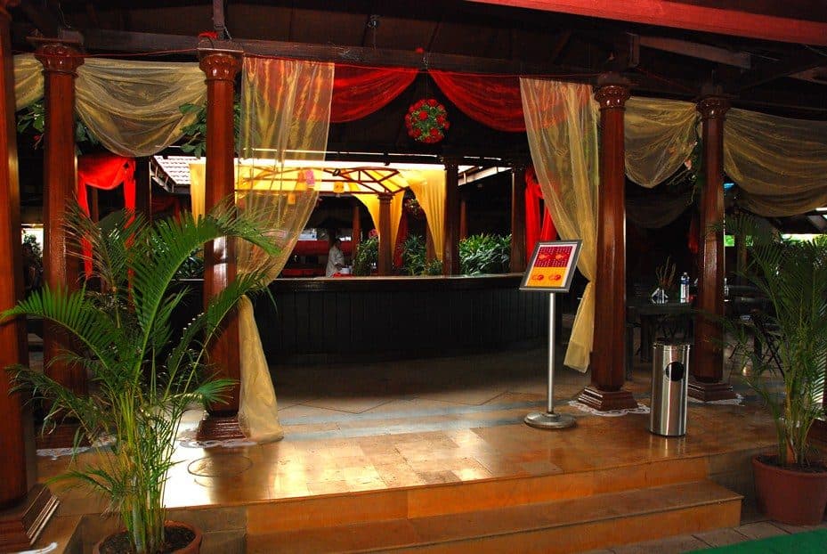 Dining — Open Air Restaurant Entrance Drapes Lit Evening
