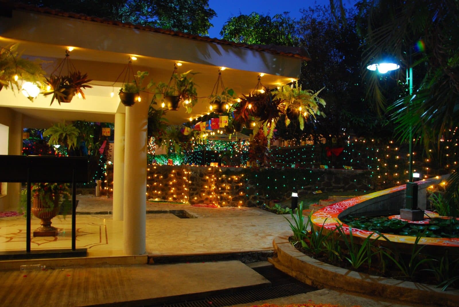 Resort Grounds — Illuminated Entrance Pergola Lily Pond Evening