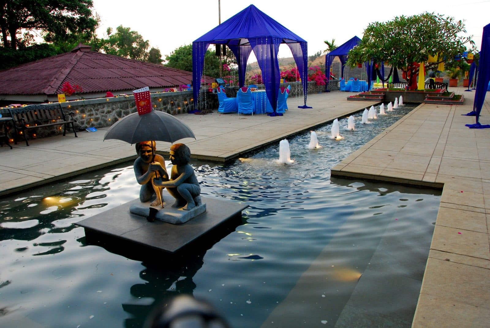 Infinity Pool — Fountain Pool Umbrella Statue Blue Cabanas